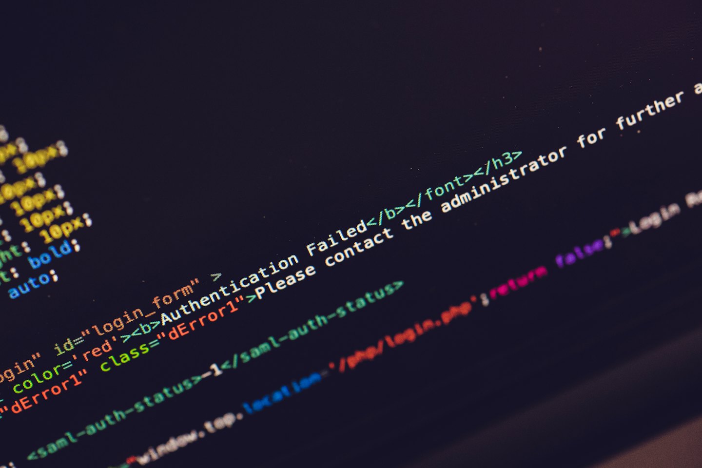 Green and white programming code on a dark computer screen.